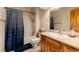 A full bathroom features a shower-tub combo, wooden vanity, and decorative mirror at 250 Upper Forest Rd, Idaho Springs, CO 80452