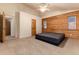Large bedroom with vaulted ceiling, log accent wall, and comfortable carpeting at 250 Upper Forest Rd, Idaho Springs, CO 80452
