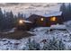 Charming mountain home with a detached garage and snow covered yard at 250 Upper Forest Rd, Idaho Springs, CO 80452