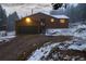 Quaint home featuring a two-car garage and cozy front porch at 250 Upper Forest Rd, Idaho Springs, CO 80452