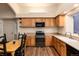Well-lit kitchen featuring wooden cabinetry, stainless steel appliances, and hardwood flooring at 250 Upper Forest Rd, Idaho Springs, CO 80452