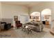 Bright, staged living room featuring a fireplace and access to the kitchen at 250 Upper Forest Rd, Idaho Springs, CO 80452