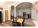 Open living room featuring vaulted ceilings, hardwood floors and a cozy fireplace with log storage at 250 Upper Forest Rd, Idaho Springs, CO 80452