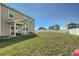 A grassy fenced backyard includes a covered porch and patio area at 529 Beckwourth, Fort Lupton, CO 80621