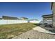 Spacious backyard with a slide, a picnic table, and a white fence at 529 Beckwourth, Fort Lupton, CO 80621