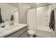 Bright bathroom featuring a shower-tub combo with white tile and a marble countertop vanity at 529 Beckwourth, Fort Lupton, CO 80621