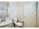 This is a well-lit half-bathroom with a sleek white sink and a tiled floor at 529 Beckwourth, Fort Lupton, CO 80621