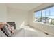 Well-lit bedroom with a large window offering neighborhood views and a comfortable armchair at 529 Beckwourth, Fort Lupton, CO 80621