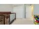 A Bedroom featuring a crib, closet and a door to another room at 529 Beckwourth, Fort Lupton, CO 80621