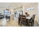 Charming dining area with hardwood floors, a chandelier, and easy access to the modern kitchen at 529 Beckwourth, Fort Lupton, CO 80621