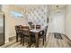 Elegant dining area featuring hardwood floors, a decorative chandelier, and eye-catching wallpaper at 529 Beckwourth, Fort Lupton, CO 80621