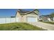 Two-story home with a two-car garage, solar panels, and a privacy fence surrounding the backyard at 529 Beckwourth, Fort Lupton, CO 80621