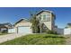 Charming two-story home showcasing a well-maintained lawn, two-car garage, and inviting curb appeal at 529 Beckwourth, Fort Lupton, CO 80621