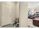 Hallway leading to a living area featuring a patterned floor and a white door at 529 Beckwourth, Fort Lupton, CO 80621