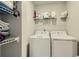 Efficient laundry room with side by side washer and dryer and shelving for storage at 529 Beckwourth, Fort Lupton, CO 80621