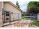 Backyard dog run area with access to the back entrance of the house and a metal fence at 4571 S Memphis St, Aurora, CO 80015