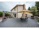 Backyard view of back of house with a back deck with seating and umbrella at 4571 S Memphis St, Aurora, CO 80015