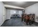 Finished basement area with a game table, a table with chairs, and gray walls at 4571 S Memphis St, Aurora, CO 80015