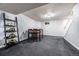 Finished basement with a table and chairs, and a staircase with white railing at 4571 S Memphis St, Aurora, CO 80015