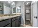Well-lit bathroom featuring granite countertops and tiled floors at 4571 S Memphis St, Aurora, CO 80015