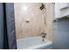 Cozy bathroom with tiled shower and bath featuring handheld shower head at 4571 S Memphis St, Aurora, CO 80015