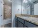 Clean bathroom featuring granite countertops and a shower with tiled walls at 4571 S Memphis St, Aurora, CO 80015