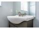 Modern bathroom with a stylish vanity, a vessel sink, and a large mirror at 4571 S Memphis St, Aurora, CO 80015