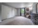 Bedroom featuring soft carpet, window with outside view, and closet with sliding doors at 4571 S Memphis St, Aurora, CO 80015