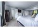 Spacious bedroom with large bed, neutral carpet, and a window with view of the outdoors at 4571 S Memphis St, Aurora, CO 80015