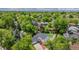 Aerial view of a two-story home with manicured landscaping, mature trees, and an attached garage at 4571 S Memphis St, Aurora, CO 80015