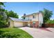 Charming two-story home with attached two-car garage, brick accents, and manicured front lawn at 4571 S Memphis St, Aurora, CO 80015