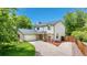Beautiful two-story home with an attached garage, lush lawn, and a long driveway on a sunny day at 4571 S Memphis St, Aurora, CO 80015