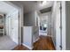 Hallway with wood floors leading to bedrooms, filled with natural light at 4571 S Memphis St, Aurora, CO 80015