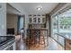 Eat-in kitchen with an island, barstool seating, and sliding door access to outdoor patio at 4571 S Memphis St, Aurora, CO 80015