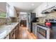 Charming kitchen featuring granite countertops, stainless steel appliances, and hardwood floors at 4571 S Memphis St, Aurora, CO 80015