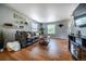 Comfortable living room with hardwood floors, a plush sofa, and bright natural light at 4571 S Memphis St, Aurora, CO 80015