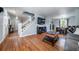 Inviting living room with hardwood floors, staircase, and a view into the dining area at 4571 S Memphis St, Aurora, CO 80015