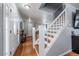 Spacious living room with hardwood floors, staircase, front door and a fireplace at 4571 S Memphis St, Aurora, CO 80015