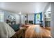 Cozy living room with hardwood floors, a brick fireplace, and access to the kitchen at 4571 S Memphis St, Aurora, CO 80015