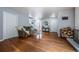Spacious living room with hardwood floors, a fireplace, and a clear view of the front entrance at 4571 S Memphis St, Aurora, CO 80015