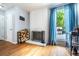 Cozy living room features a brick fireplace, wood floors, and access to the outdoor deck at 4571 S Memphis St, Aurora, CO 80015