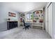 Bright office space featuring built-in shelving and a view of the outdoors at 4571 S Memphis St, Aurora, CO 80015