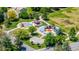 Aerial view of neighborhood playground with mature trees, colorful design, and paved paths at 4571 S Memphis St, Aurora, CO 80015