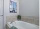 Elegant bathroom featuring a soaking tub with a stylish tile surround, and a clean, modern design at 6283 Kilmer Loop # 201, Golden, CO 80403