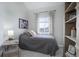 Bedroom with vaulted ceiling, window, side table, decorative book shelf, and neutral color scheme at 6283 Kilmer Loop # 201, Golden, CO 80403