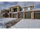 Exterior view of condo with three garage doors, stone accents and balcony at 6283 Kilmer Loop # 201, Golden, CO 80403