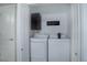 Laundry room with washer and dryer, black storage cabinet and laundry sign inside closet at 6283 Kilmer Loop # 201, Golden, CO 80403