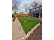 Landscaped backyard with artificial turf and fire pit at 12555 W 61St Ave, Arvada, CO 80004