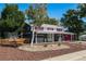 Ranch style home with red accents and landscaped yard at 12555 W 61St Ave, Arvada, CO 80004