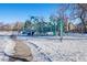 Modern playground covered in snow, located in a park at 12555 W 61St Ave, Arvada, CO 80004